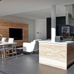 Kitchen with flat cabinet doors finished in natural wood