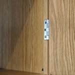 Close up of an in-frame cabinet showing the butt hinge