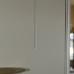 A close up of a lay-on kitchen cabinet with hidden Blum hinges