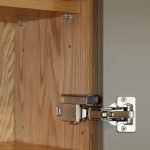 A close up of a lay-on kitchen cabinet showing the hidden Blum hinges