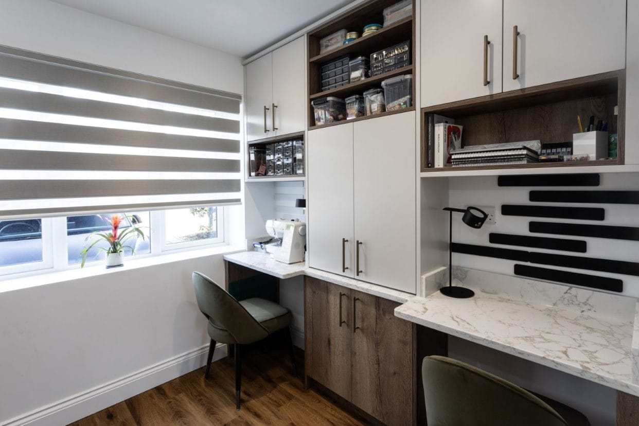 View of the craft room shelving showing the desk and storage space in more detail.