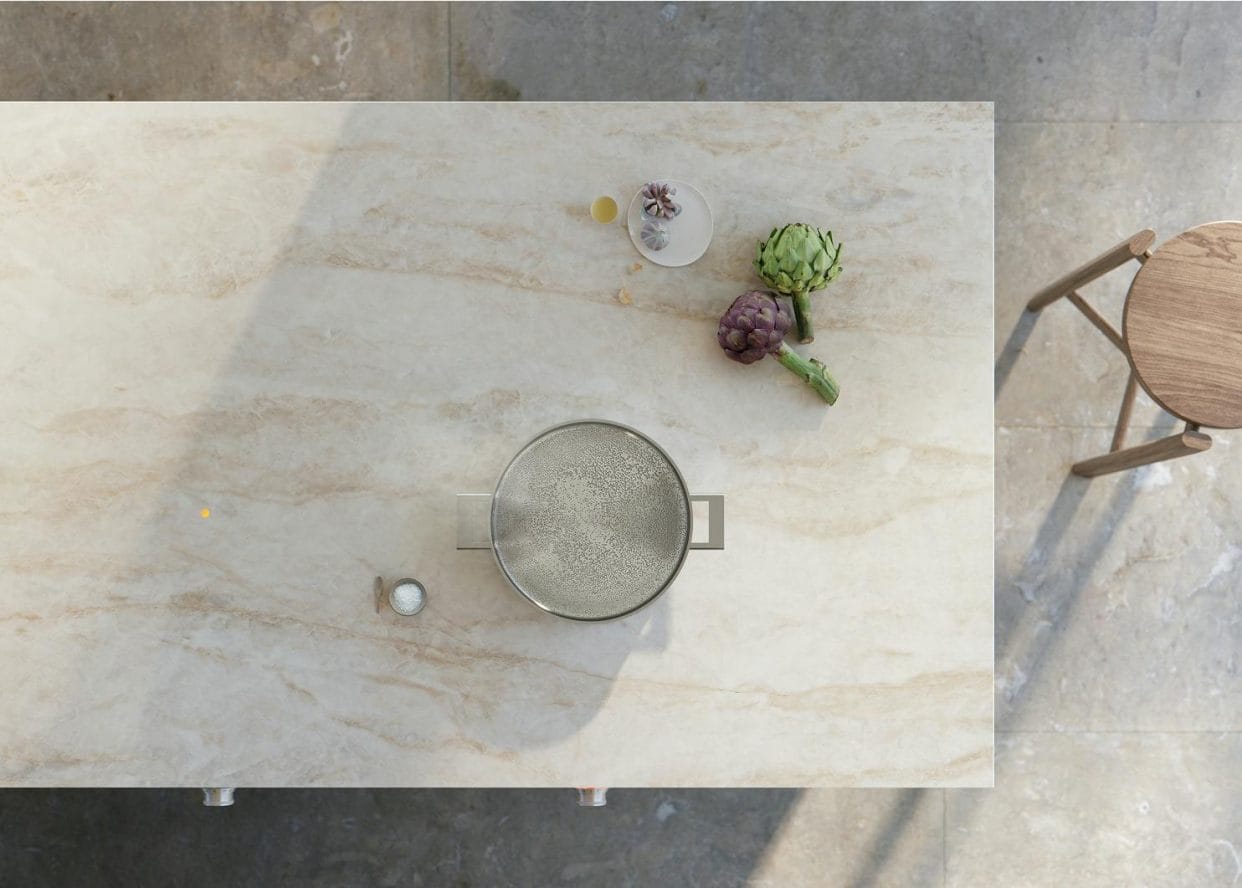 A kitchen island seen from above featuring a marble-inspired Dekton work surface