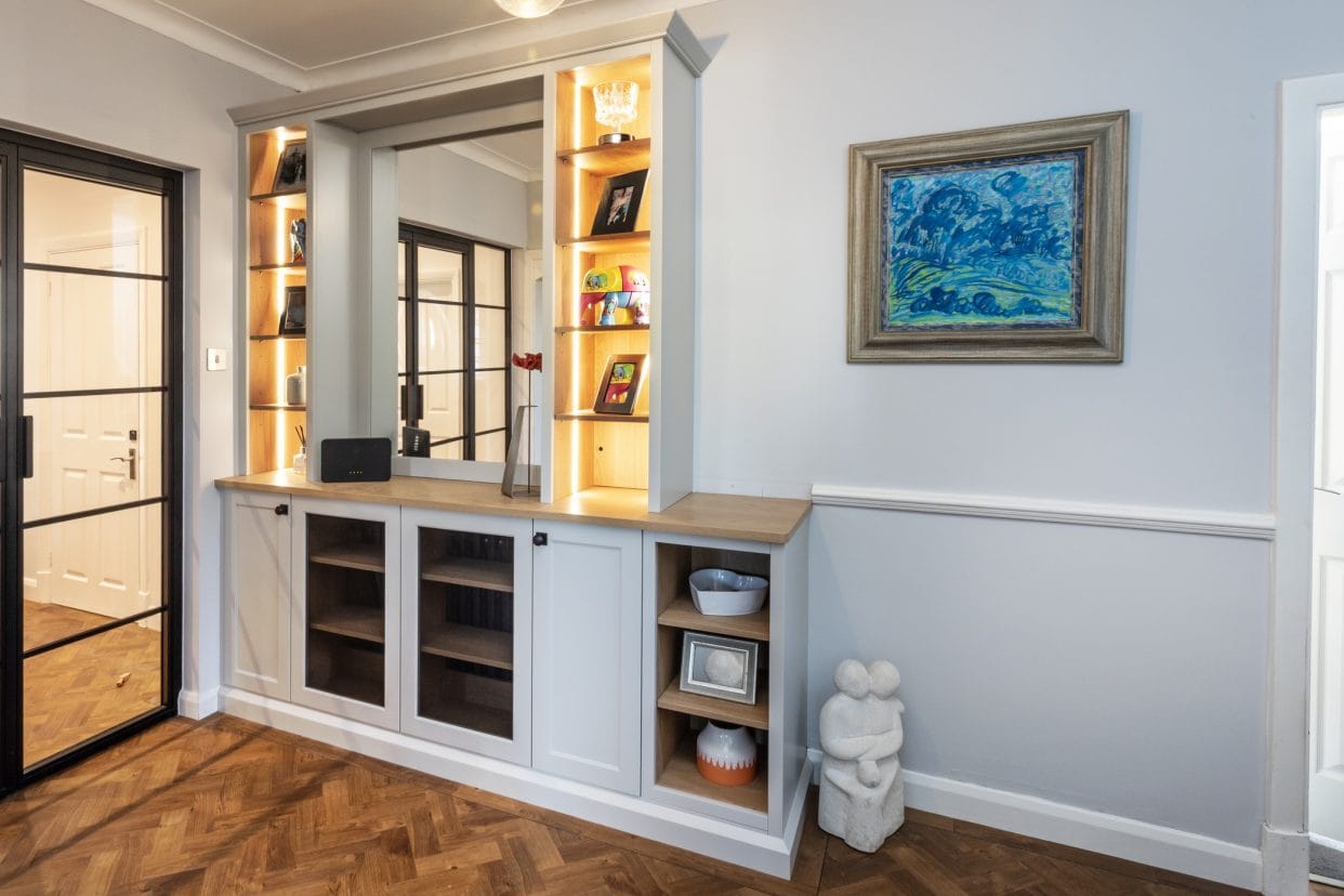 Practical yet elegant hallway storage with open shelving and cupboards with fine mesh detailing.